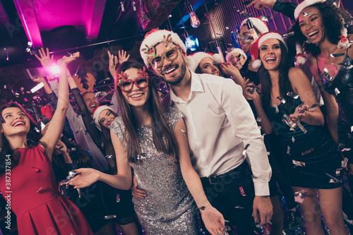 Photo of positive people man embrace charming girl toothy smile camera deer x-mas glasses modern club indoors