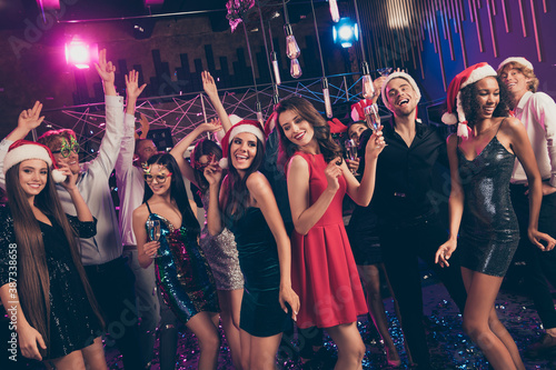 Photo of people party fancy ladies hold wineglass wear colorful red mini dress x-mas headwear modern club indoors