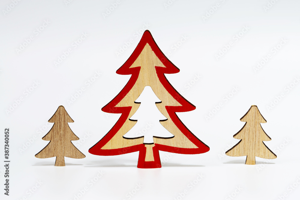 Obraz premium Christmas trees made of natural wood, isolated on a white background with a soft shadow. The concept of Christmas decorations.