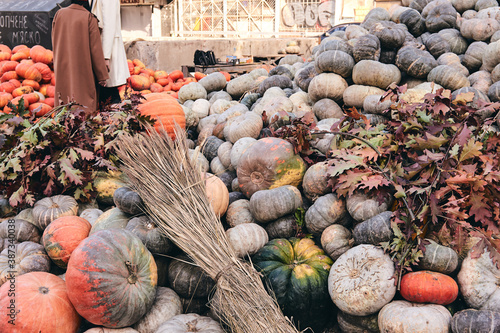 A lot decorative pumpkins and flowers at farm market. Thanksgiving holiday season and Halloween decor. Autumn harvers, fall natura consept photo