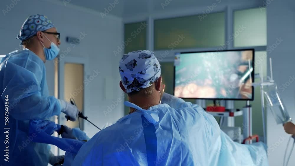 Doctors during surgery in uniform. Portrait of team of professional doctors working in the operating room during surgery Doctors during surgery in uniform. Portrait of team of professional doctors working in the operating room during surgery