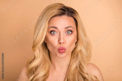 Close up photo of beautiful lady with aesthetic appearance sending air kiss boyfriend isolated pastel beige background
