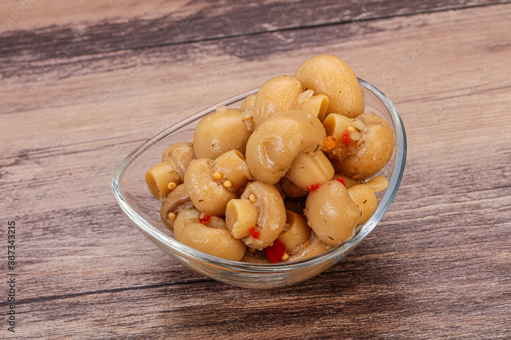 Pickled champignons in the bowl Pickled champignons in the bowl