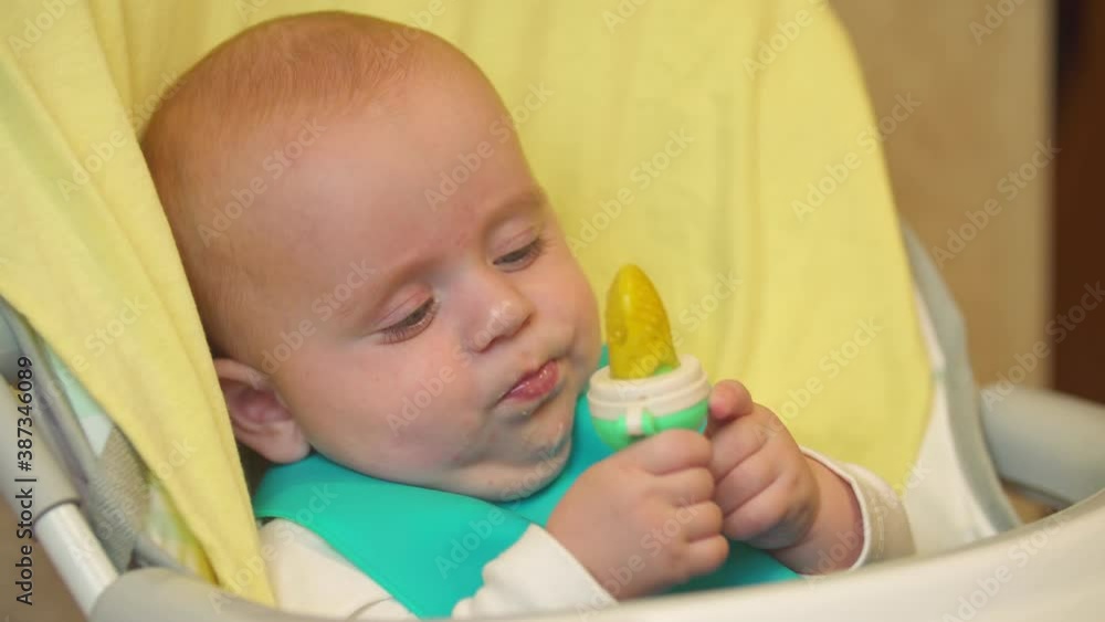 the baby sits at the table and eats the baby sits at the table and eats