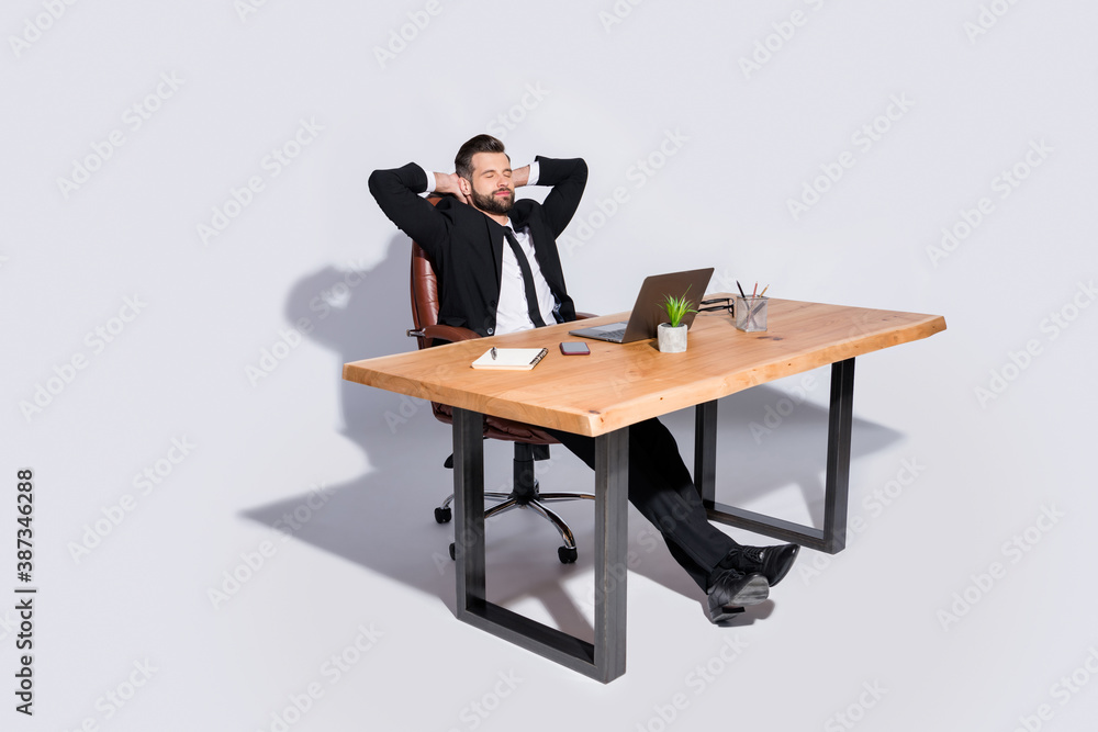 Full length photo of handsome business guy notebook table having break eyes closed hands behind head wear blazer shirt pants shoes costume sit chair isolated grey background Full length photo of handsome business guy notebook table having break eyes closed hands behind head wear blazer shirt pants shoes costume sit chair isolated grey background
