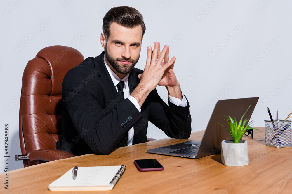 Photo of handsome macho business guy self-confident person notebook table hold fingers together intelligent chief wear black blazer shirt suit sit chair isolated grey background Photo of handsome macho business guy self-confident person notebook table hold fingers together intelligent chief wear black blazer shirt suit sit chair isolated grey background