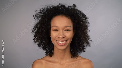 close-up portrait. attractive young female african american woman face on gray isolated background. 4K