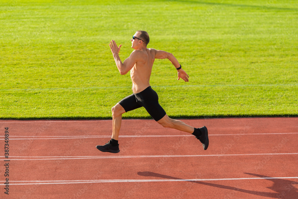 Obraz premium Runner running along the track in the stadium