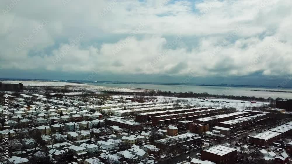 Scenic View of Grey Clouds Over Snow Covered Neighborhoods Scenic View of Grey Clouds Over Snow Covered Neighborhoods