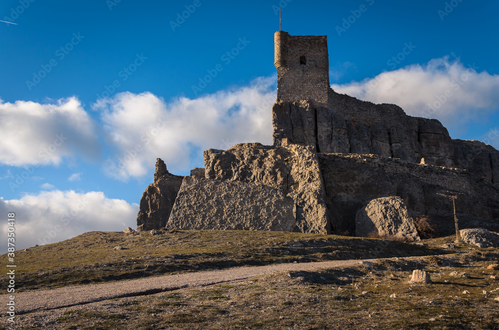 Castle Atienza on the top of the hill on a blue sky day with clouds, Guadalajara, Spain
