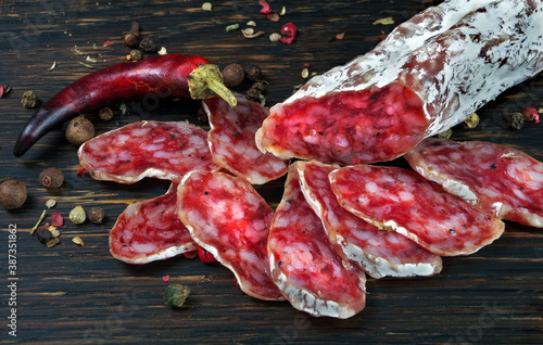 dried sausage on a wooden table. sausage fuet close-up photo