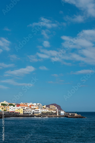 Los Abrigos with its colorful houses, the harbor and Montana Roja in the background, a picturesque village popular for pescatarian cuisine in the south of the island of Tenerife, Canary Islands, Spain