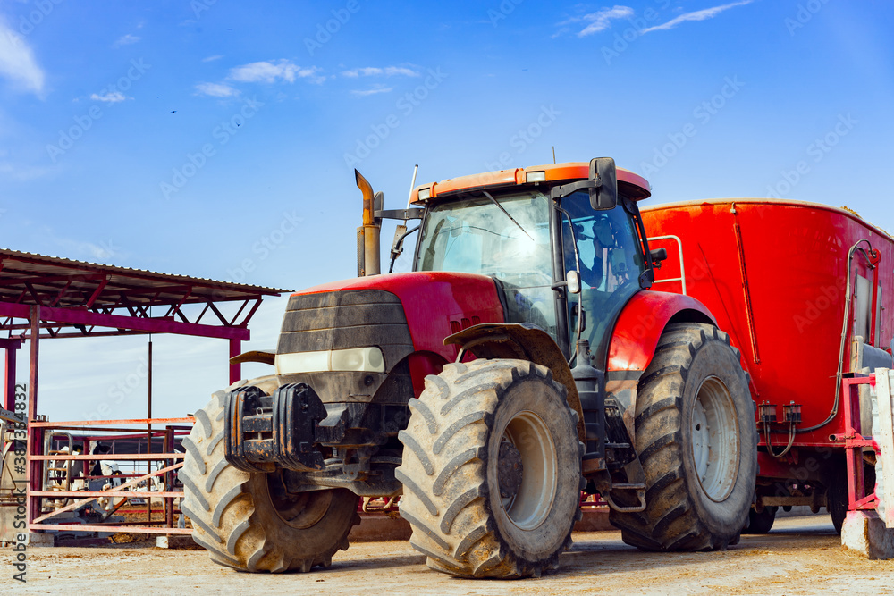 Modern red agricultural tractor in a farm Modern red agricultural tractor in a farm