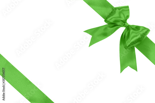 Gift card concept - shiny green satin ribbon with bow isolated on white background 