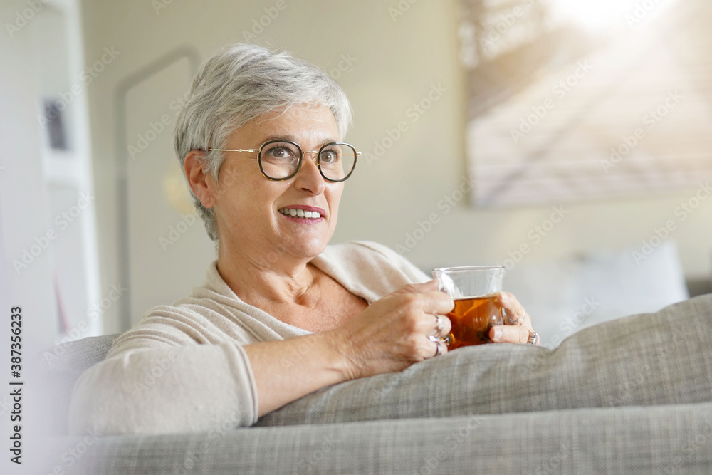 Mature woman drinking hot tea, relaxing time at home Mature woman drinking hot tea, relaxing time at home