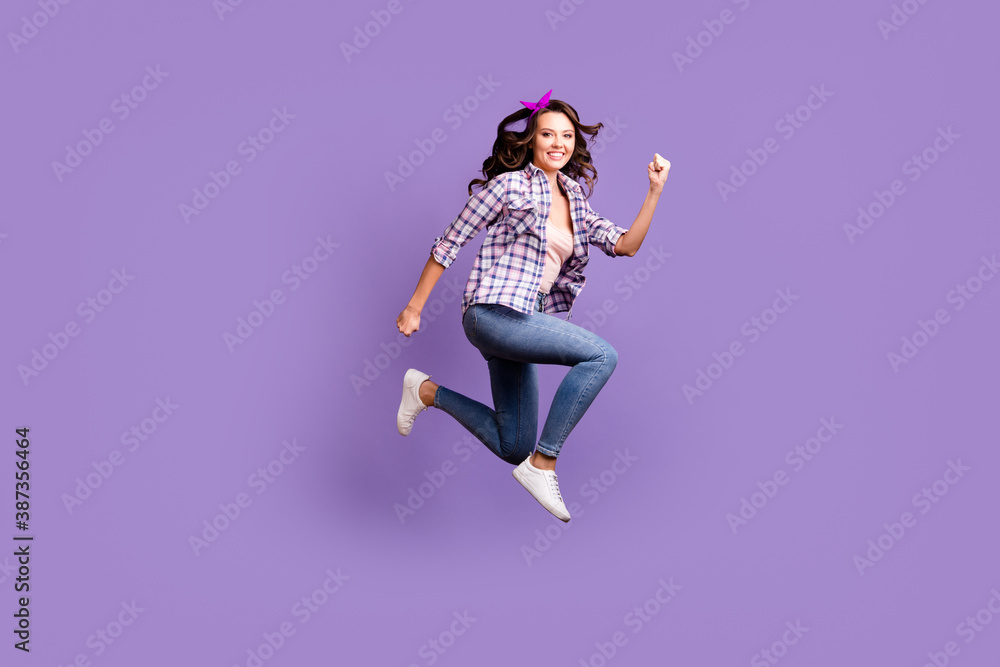 Profile photo of shiny sweet brown hair girl wear retro plaid shirt jumping high hands fists isolated purple color background
