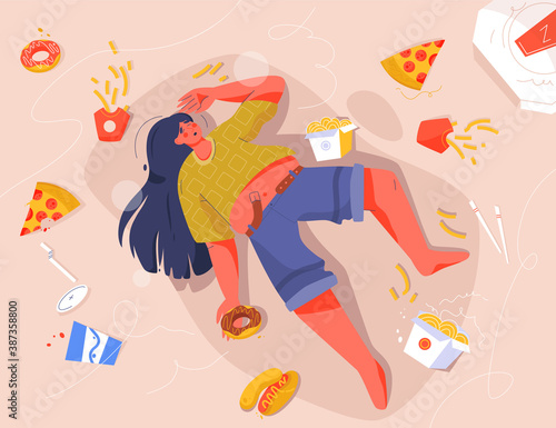 Sad fat woman eating fast food, lying on floor