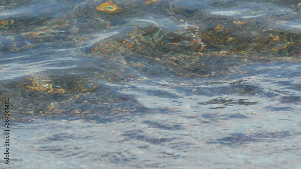 Transparent beautiful sea, waves beat against rocky pebble sand. Transparent beautiful sea, waves beat against rocky pebble sand.