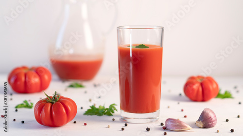 Tomato juice and fresh red tomatoes