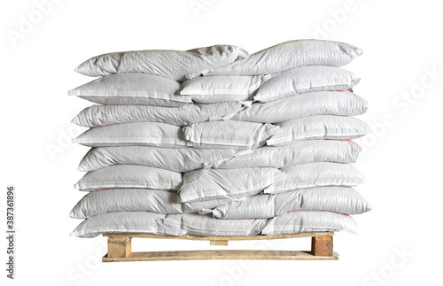 Photo Full white bags stacked on a pallet on isolated white background