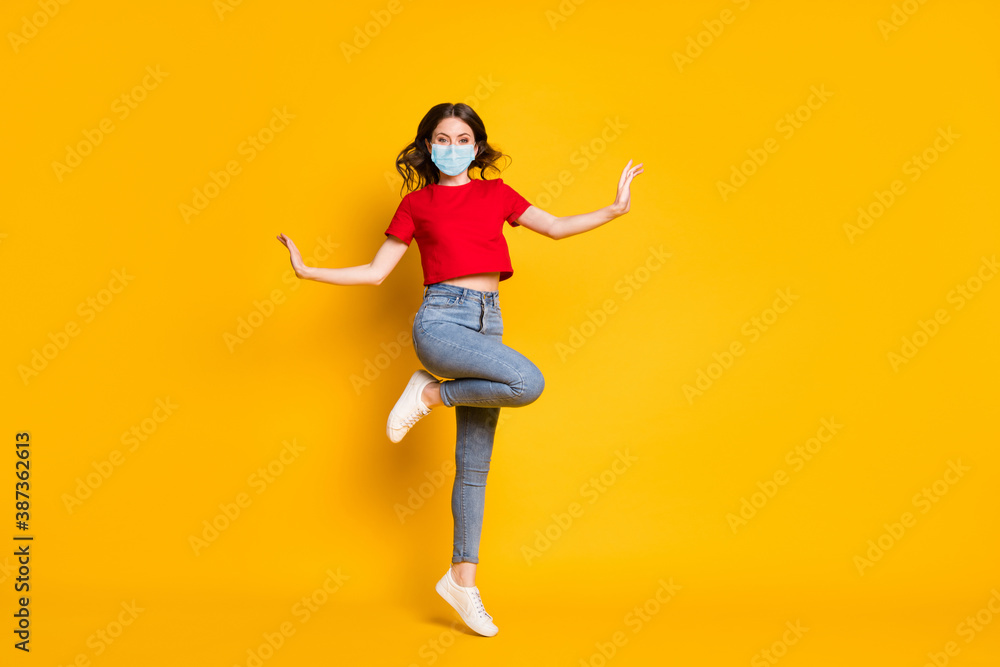 Full size photo of girl jump wear red clothes footwear wear mask isolated over shine color background