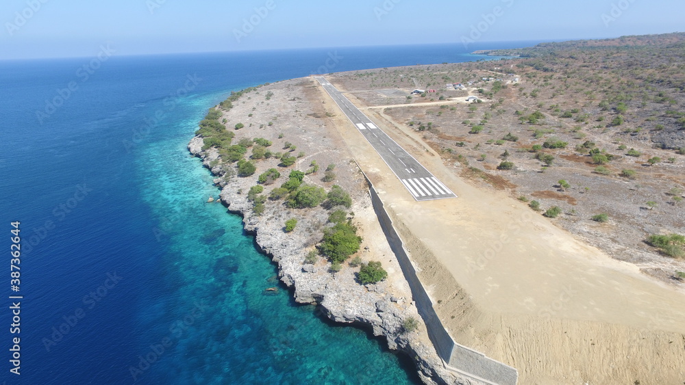 This is an airstrip on the island of Kisar close to the ocean This is an airstrip on the island of Kisar close to the ocean