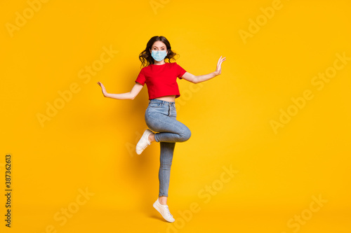 Full size photo of girl jump wear red clothes footwear wear mask isolated over shine color background