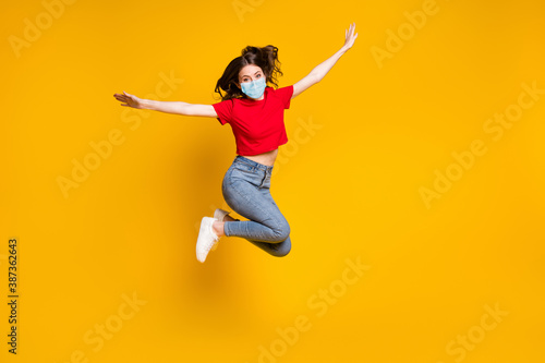 Full size photo of crazy cheerful girl jump hold hand wear mask isolated over vivid color background