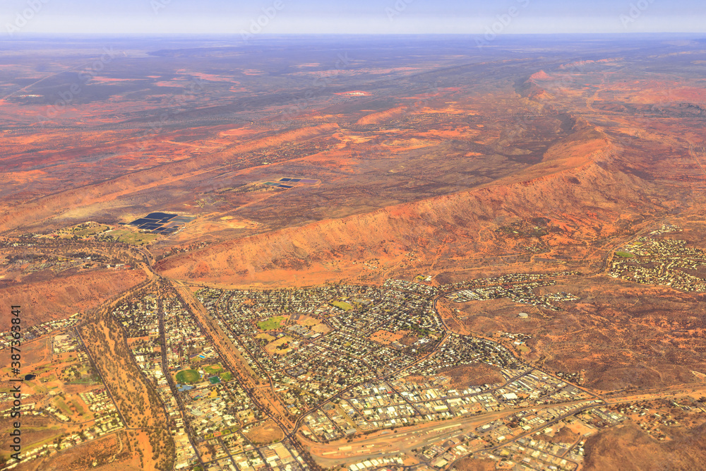 Aerial view of Alice Springs city of Red Centre desert with Macdonnell ranges of Northern Territory in Central Australia. Alice Springs Australian scenic flight for tourists.