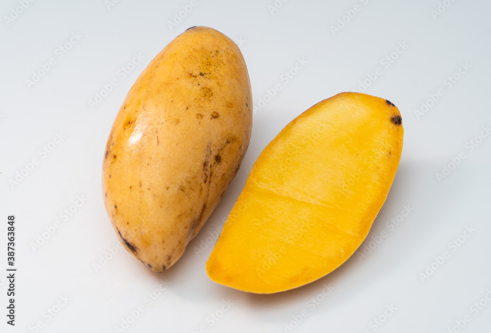 Disease mango on a white background, a black spot on the surface of the mango is often referred to as anthracnose. Disease mango on a white background, a black spot on the surface of the mango is often referred to as anthracnose.
