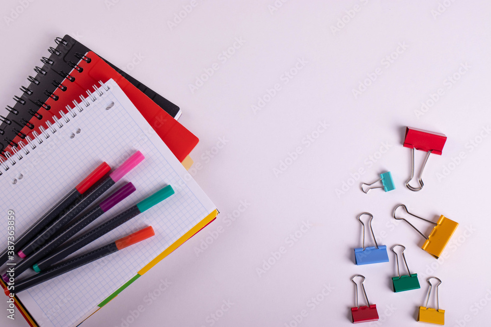 different stationary items of various colours on light surface. different stationary items of various colours on light surface.