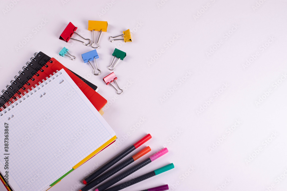 different stationary items of various colours on light surface. different stationary items of various colours on light surface.