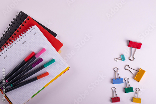 different stationary items of various colours on light surface.