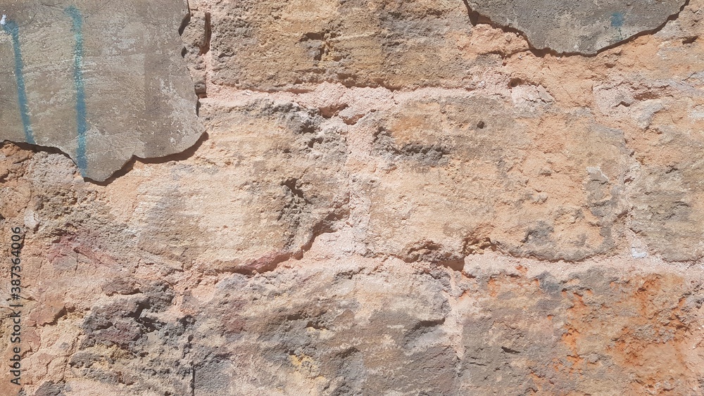 Obraz premium An old damaged stone wall