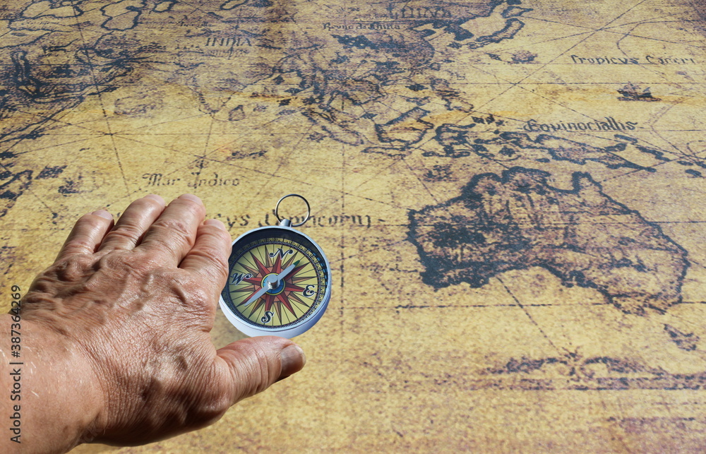 Classic round compass on background of old vintage map of world as ...