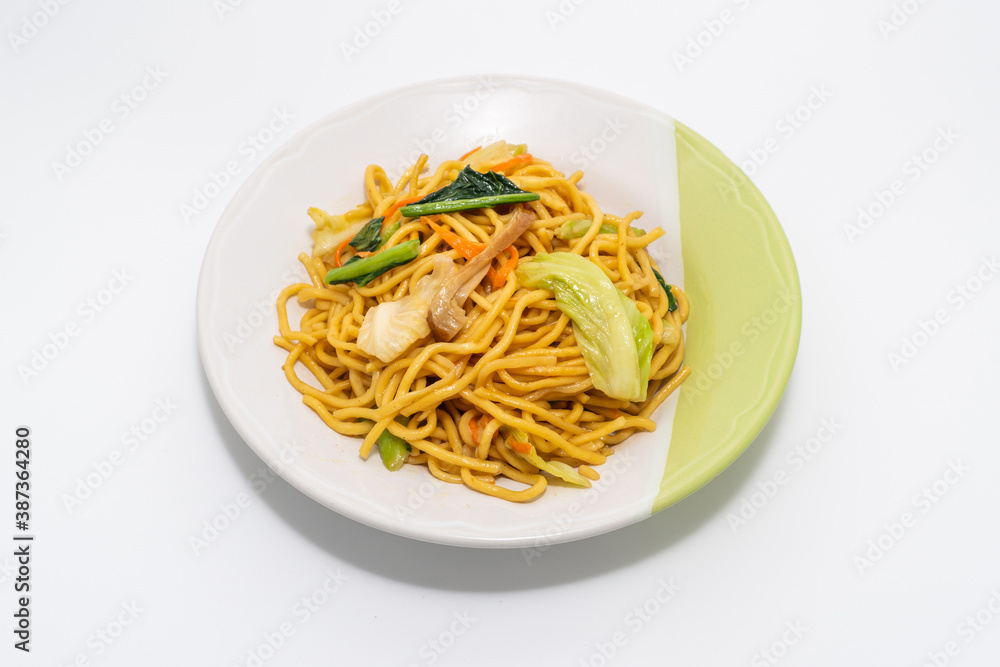Chinese-Styled Fried Noodle on plate isolated on a white background, Vegetarian Festival.
