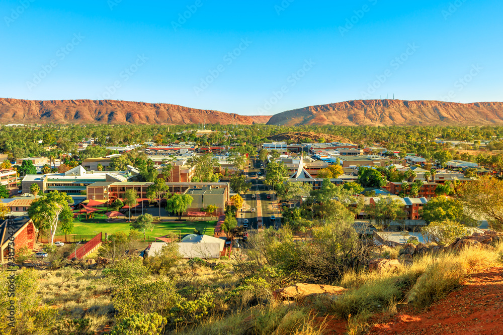 Aerial view of Alice Springs skyline in Australia from Anzac Hill Memorial lookout with main buildings of Alice Springs city downtown. Red Centre desert with Macdonnell ranges of Northern Territory.