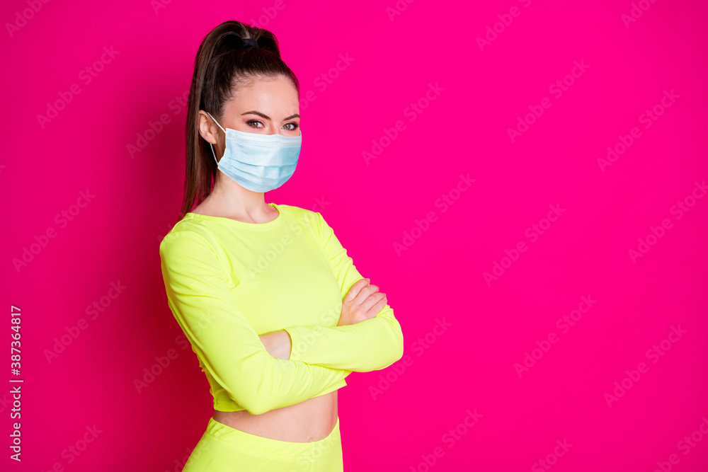 Profile of charming woman stand crossed hands dress mask sport suit look empty space isolated on vibrant shine pink color background Profile of charming woman stand crossed hands dress mask sport suit look empty space isolated on vibrant shine pink color background
