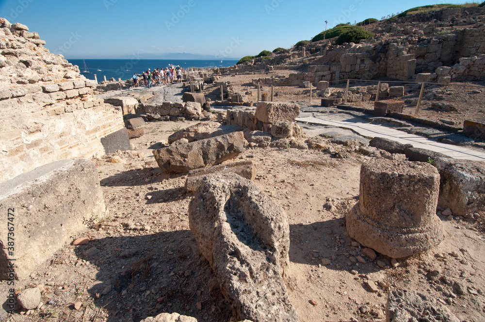 Obraz premium Tharros, Archeological area, Punic and Roman ruins and blue sea in Sardinia