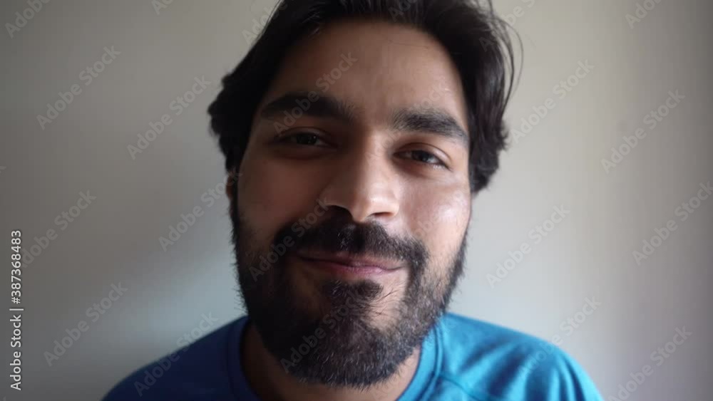 Casual Indian Man Smiling At The Camera And Drinks Water In Tumbler - close up Casual Indian Man Smiling At The Camera And Drinks Water In Tumbler - close up
