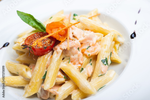 Traditional Italian pasta penne with salmon and creamy sauce.