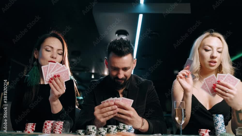 Man betting all in. Bearded man and two beauty girls are playing at the casino Man betting all in. Bearded man and two beauty girls are playing at the casino