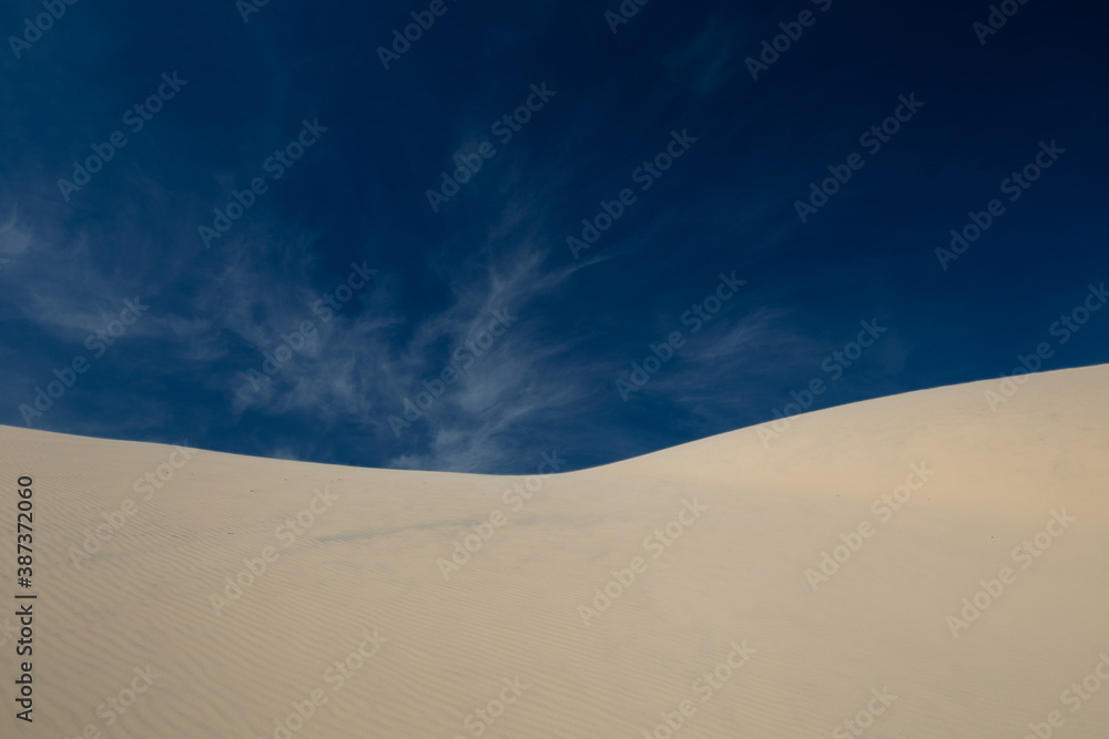 sand dunes and sky with different clouds