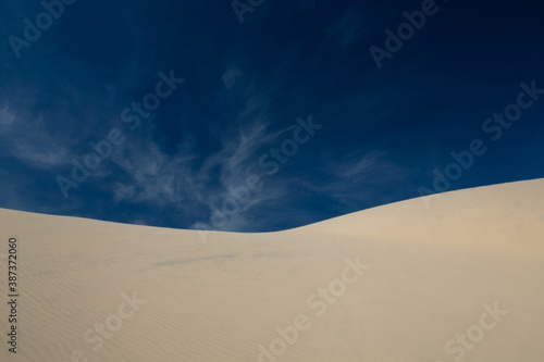 sand dunes and sky with different clouds