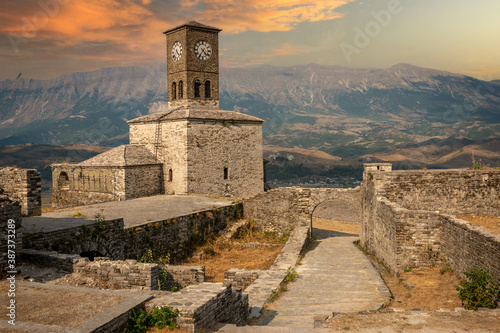 Sunset over clock tower and fortress at Gjirokaster castle, Albania