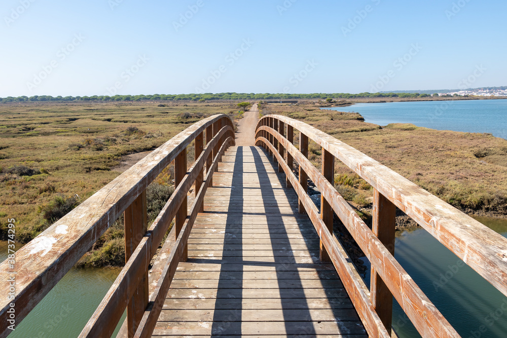 Elevated wooden boardwalk above the marshes of the Rio Piedras in El Rompido village, Huelva, Andalusia, Spain
