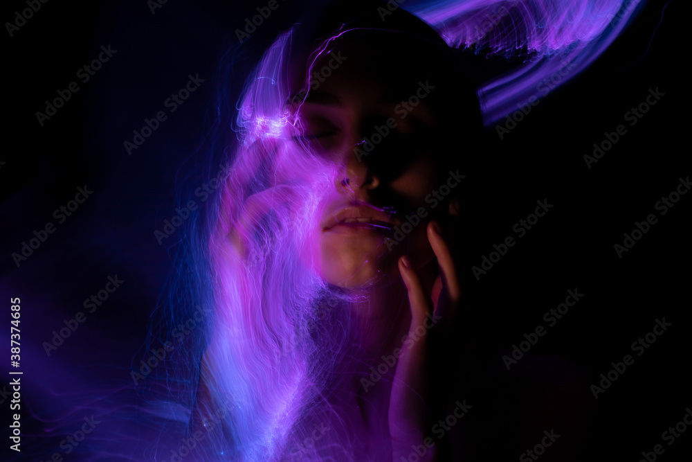 Abstract photography in the style of light painting. girl on a black background	
