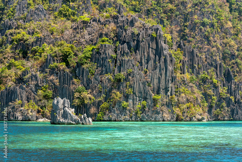 Crystal waters and rock Hill formations In El Nido Beach In The Philippines