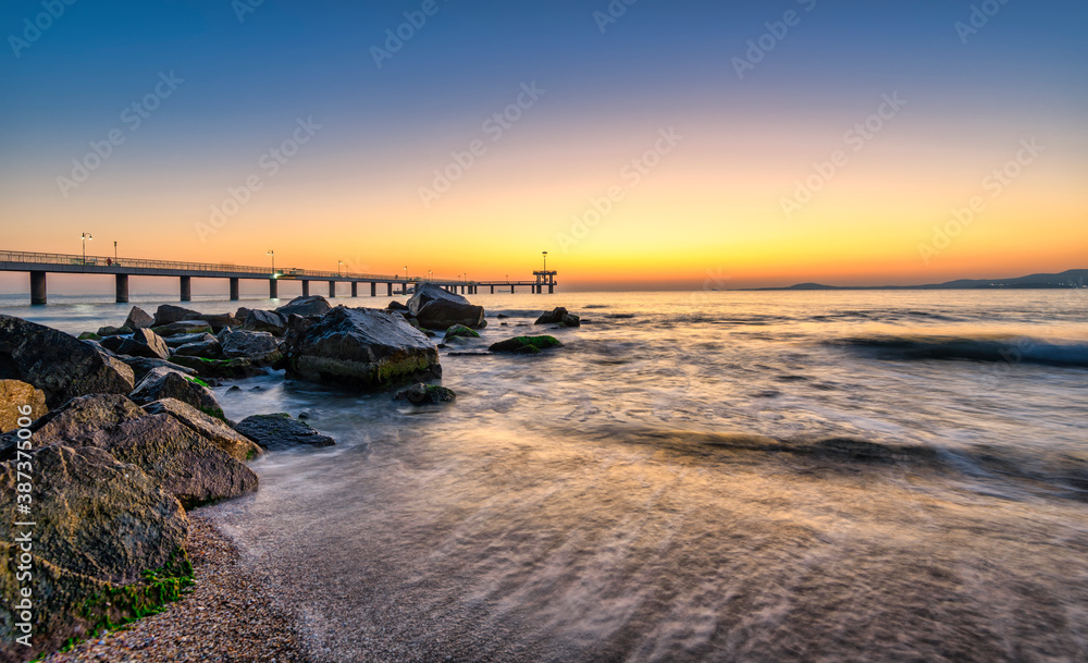 sunrise on the beach and the bridge
