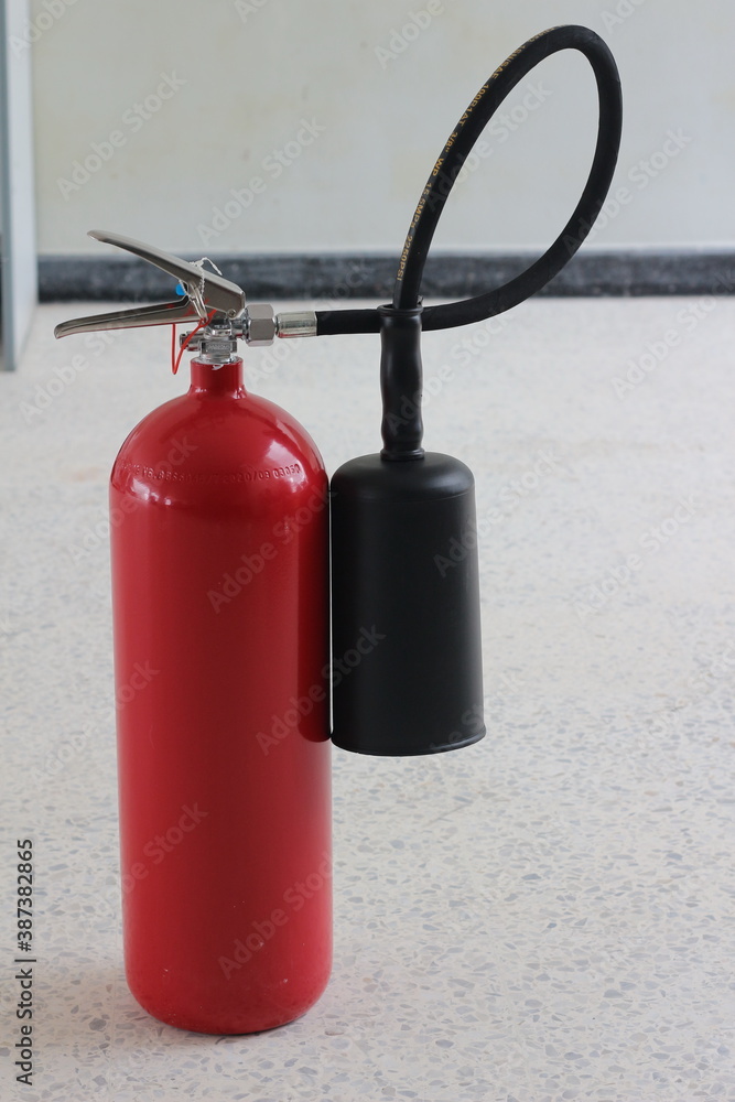 Obraz premium fire extinguisher container on wall in the building.
